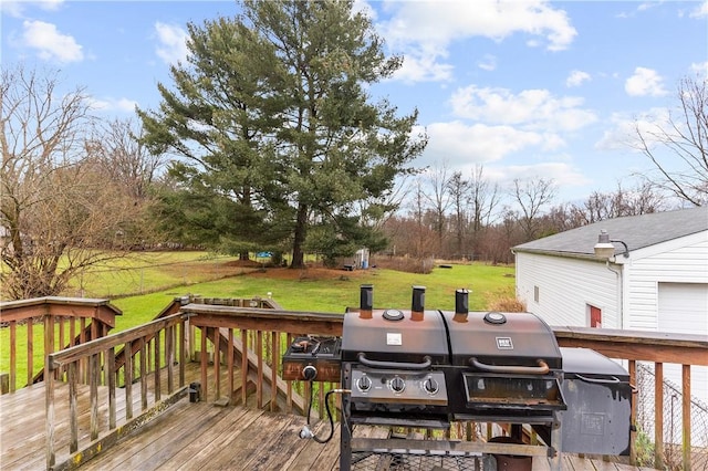 wooden deck with area for grilling and a yard