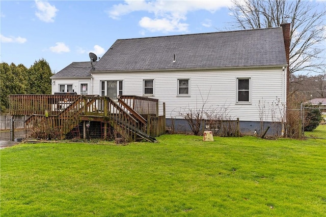 back of property featuring a deck and a lawn