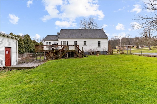 rear view of house featuring a yard and a wooden deck