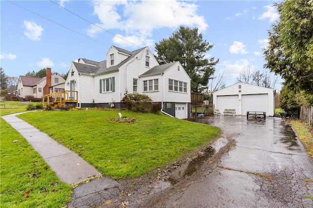 view of front of house featuring a garage, a front lawn, an outdoor structure, and a wooden deck