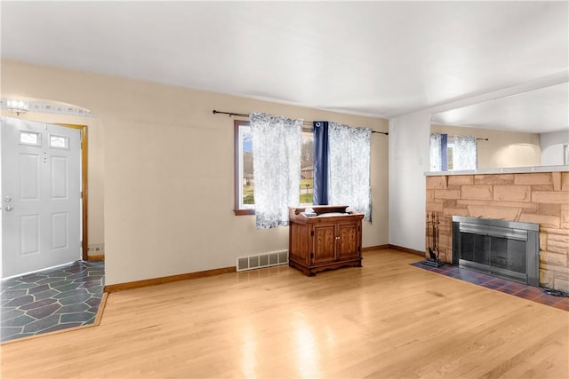 living room with hardwood / wood-style floors and a fireplace