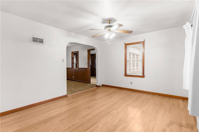 empty room with light wood-type flooring and ceiling fan