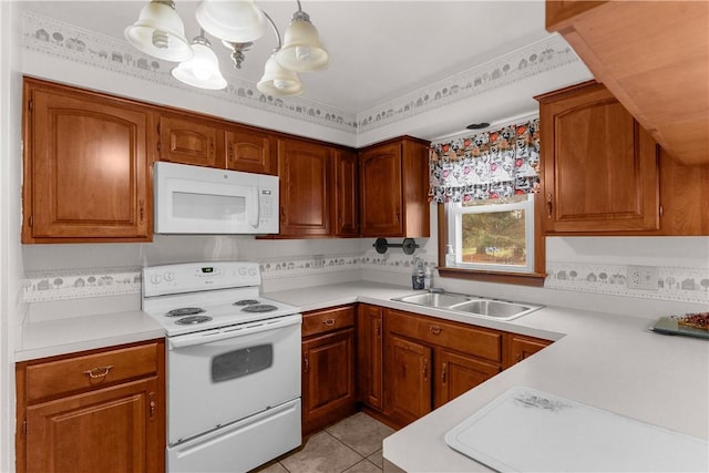 kitchen with pendant lighting, white appliances, light tile patterned floors, and sink