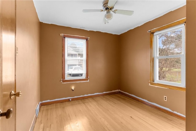 empty room featuring ceiling fan and light wood-type flooring