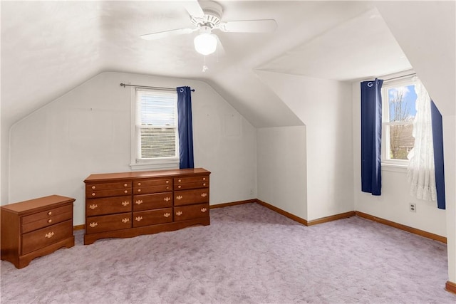 additional living space featuring light colored carpet, vaulted ceiling, and ceiling fan