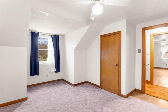 additional living space with ceiling fan, light colored carpet, and lofted ceiling