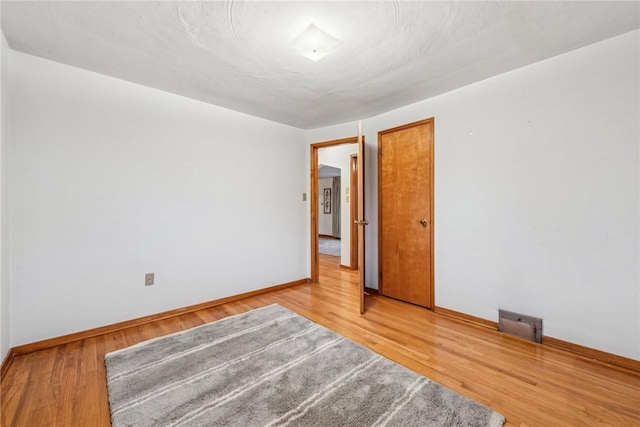 spare room featuring hardwood / wood-style floors