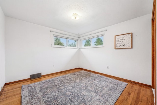 empty room with wood-type flooring