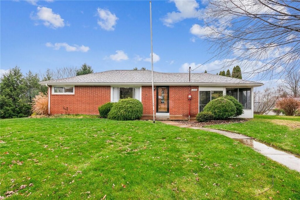 13458 Dean Dr, North Huntingdon, PA 15642 - ranch-style home with a sunroom and a front lawn