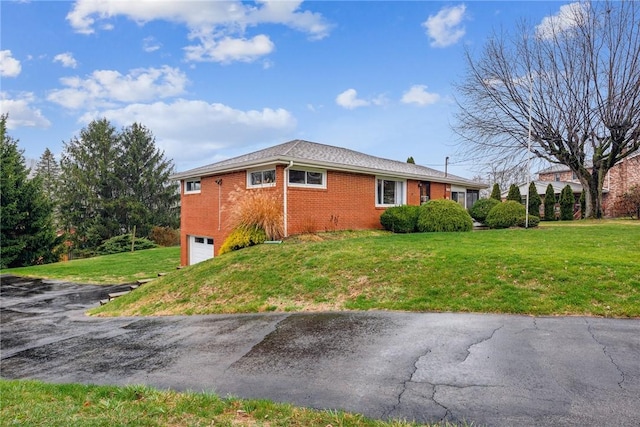 view of side of property featuring a yard and a garage