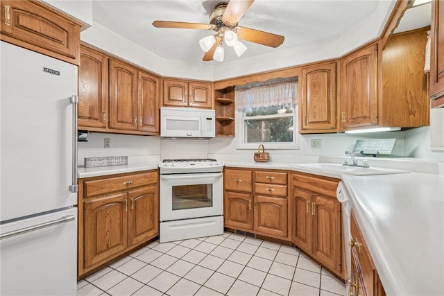 kitchen featuring ceiling fan, white appliances, sink, and light tile patterned floors