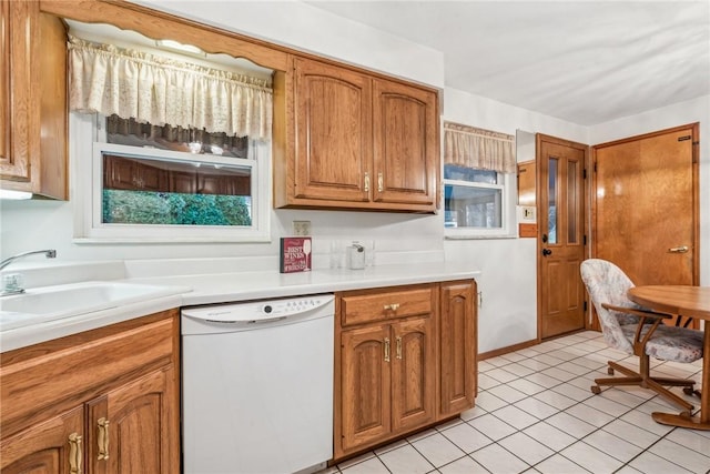 kitchen featuring light tile patterned floors, white dishwasher, and sink