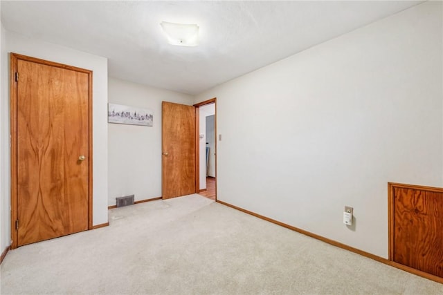 spare room with light colored carpet