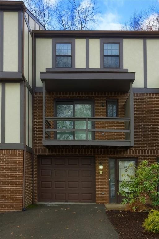 view of front of house featuring a garage and a balcony