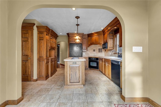 kitchen featuring a center island, sink, hanging light fixtures, decorative backsplash, and black appliances