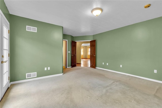 unfurnished bedroom featuring multiple windows and light carpet