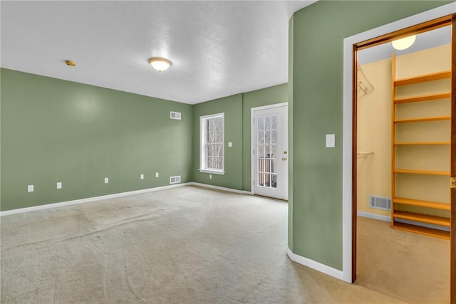 empty room featuring light colored carpet