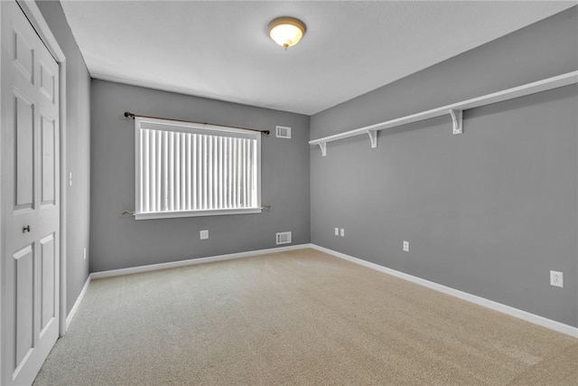 spare room with light colored carpet