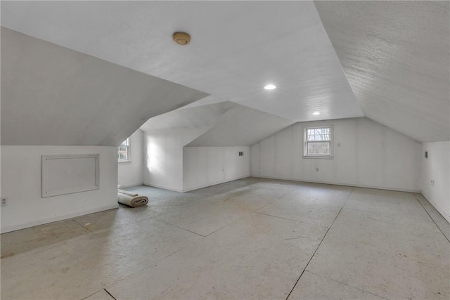 additional living space with a healthy amount of sunlight and lofted ceiling