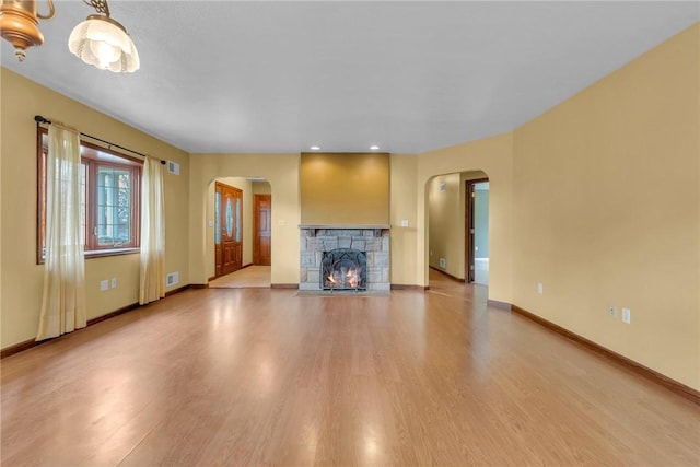 unfurnished living room with a fireplace and light hardwood / wood-style floors