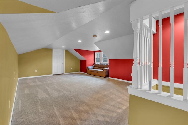 bonus room with carpet flooring and vaulted ceiling