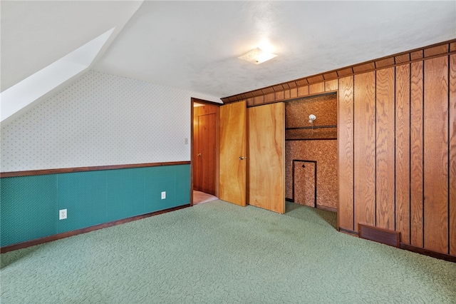 bonus room featuring dark colored carpet