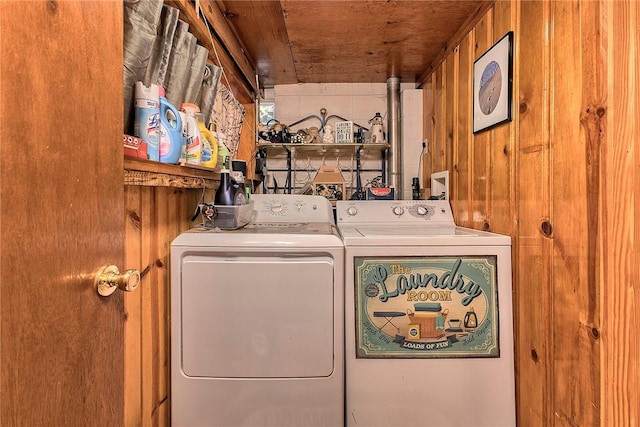 laundry area featuring wooden ceiling, wooden walls, and washing machine and clothes dryer