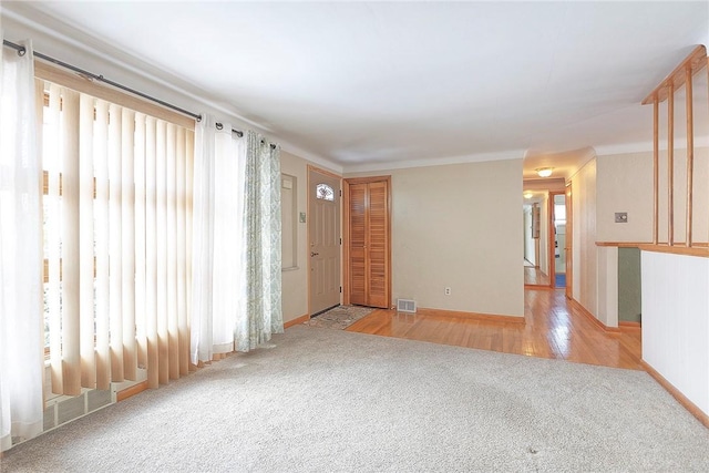 carpeted spare room featuring plenty of natural light