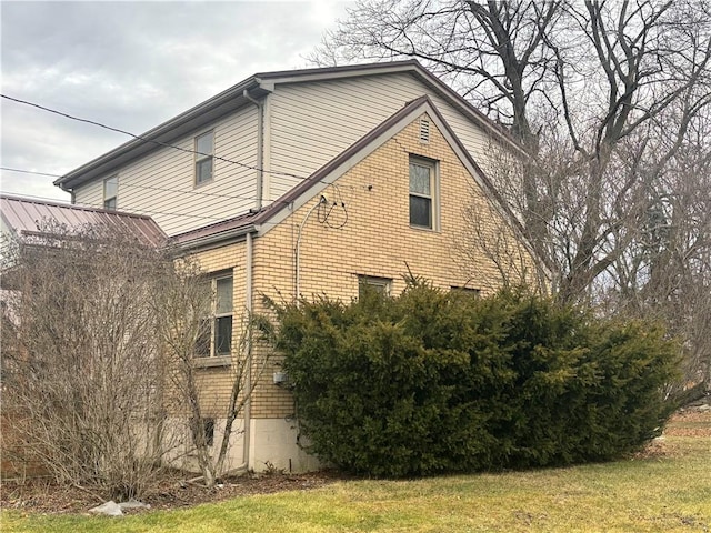 view of property exterior with a yard