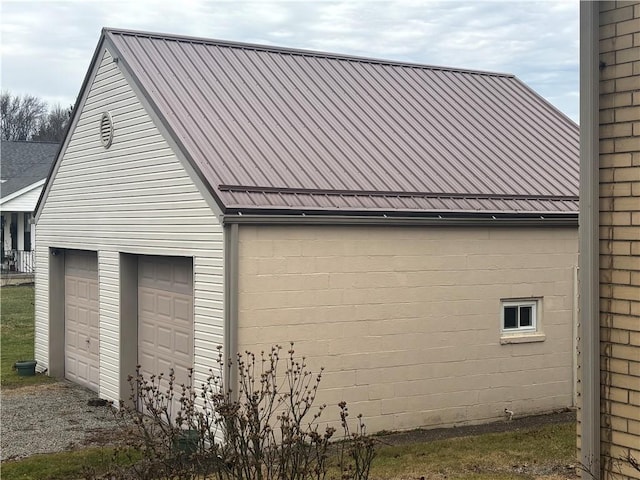 view of side of home with a garage and an outdoor structure