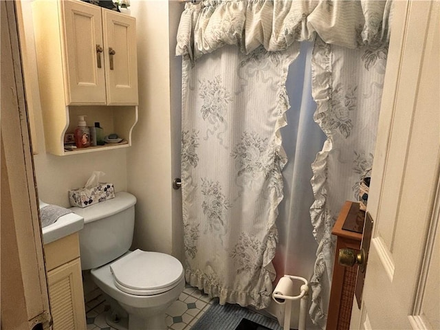 bathroom with tile patterned floors, vanity, and toilet