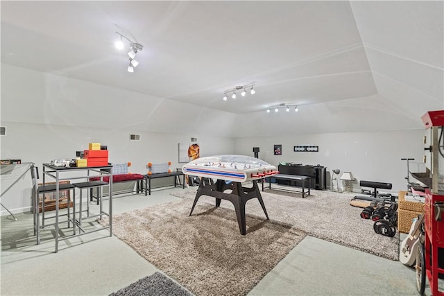 rec room featuring carpet floors and vaulted ceiling