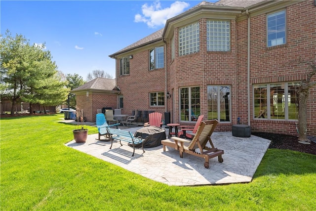 back of house with a patio area and a yard