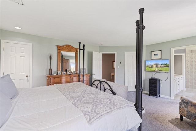 carpeted bedroom featuring connected bathroom