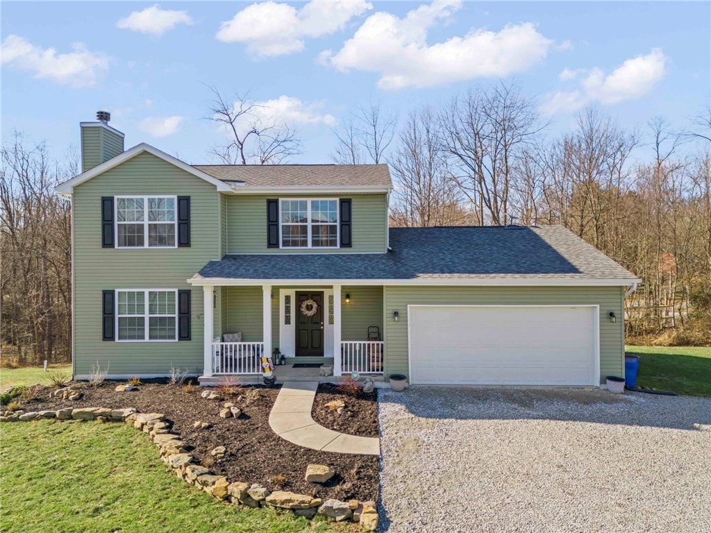 view of front property featuring a porch and a garage