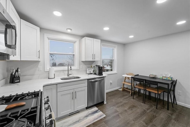 kitchen featuring white cabinets, sink, dark hardwood / wood-style floors, appliances with stainless steel finishes, and a healthy amount of sunlight