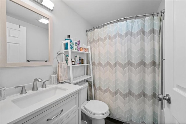 bathroom featuring walk in shower, vanity, and toilet