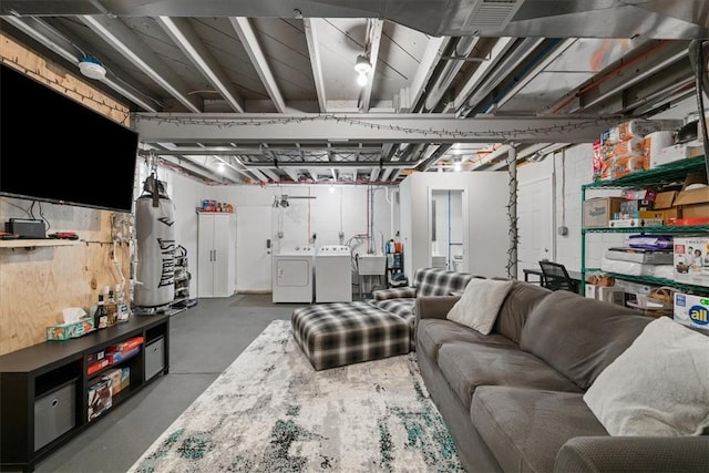 living room with concrete flooring and washer and clothes dryer