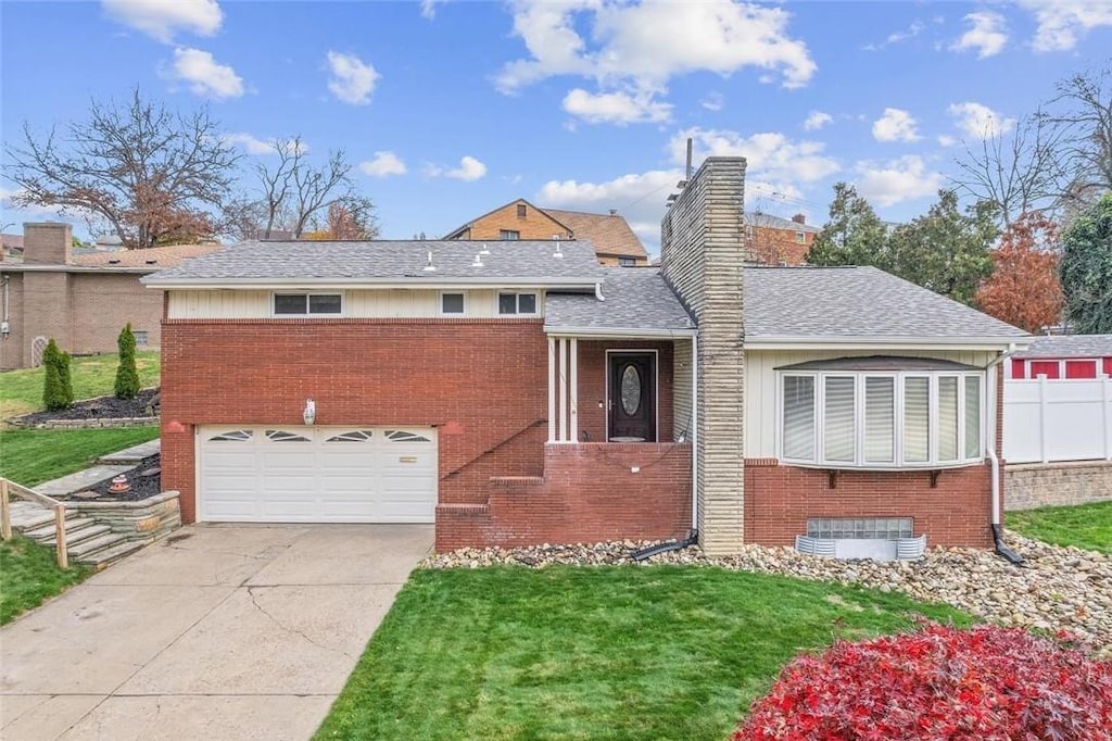 view of front of house featuring a garage and a front lawn