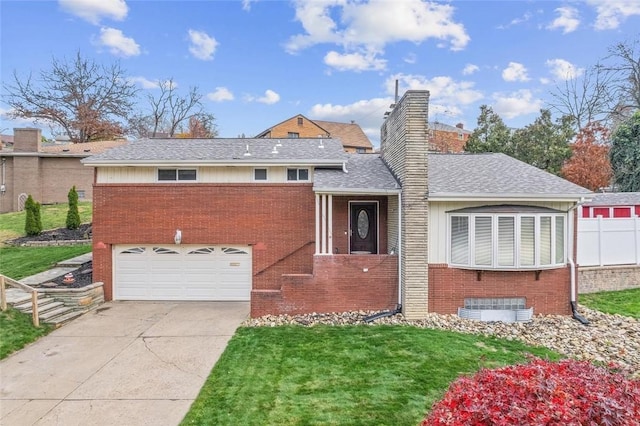 view of front of house featuring a garage and a front lawn