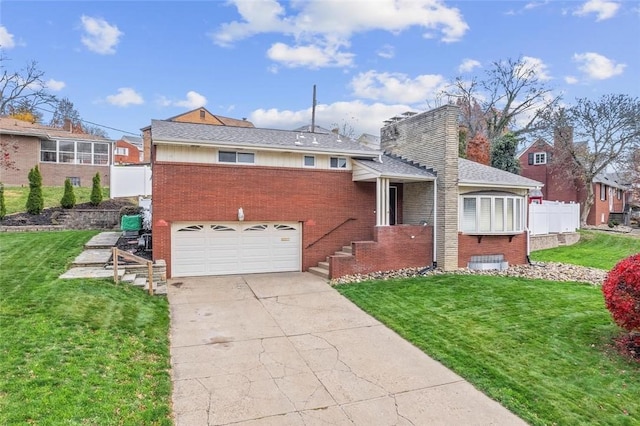 view of front of house with a front yard and a garage