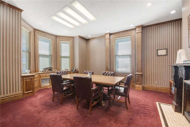 dining area featuring dark colored carpet and crown molding