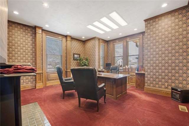 office space featuring dark carpet, ornamental molding, visible vents, and recessed lighting