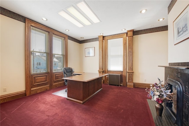 office area featuring dark colored carpet, recessed lighting, radiator heating unit, and a fireplace