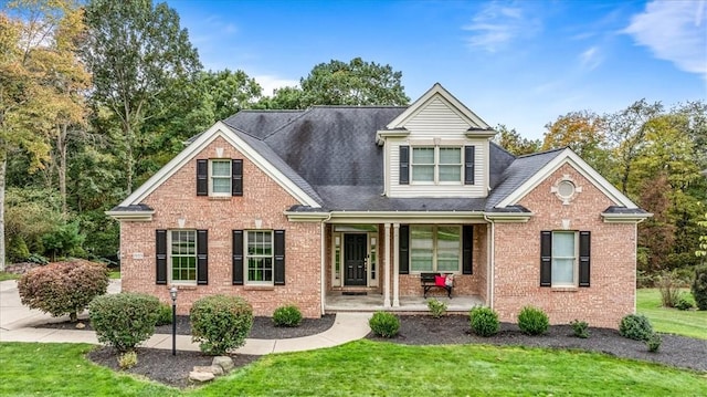 view of front of house featuring covered porch and a front yard