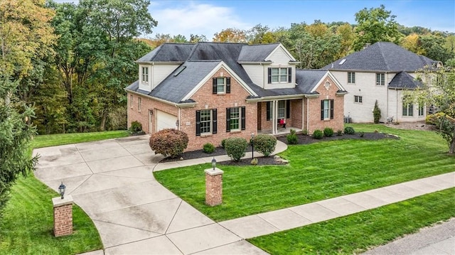 view of front of house with a garage and a front lawn