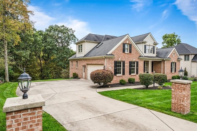 view of front of house featuring a garage and a front lawn