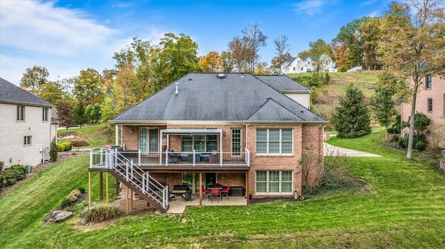 rear view of house featuring a yard, a deck, and a patio area