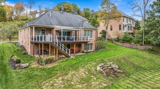 rear view of house featuring central air condition unit, a lawn, and a wooden deck