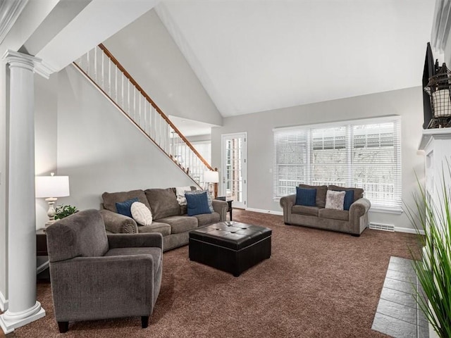 carpeted living room with high vaulted ceiling and decorative columns